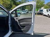 a white car with its door open in a parking lot