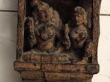 a wooden wall hanging with carvings of animals on it