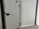 a white door with a black handle in a room