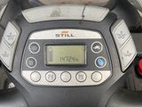 a close up of a steering wheel with a clock on it