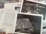 a lot of old black and white photos on the table