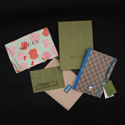 four different types of gucci wallets on a black background