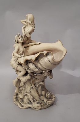 statue of a woman sitting on a shell with a child on it