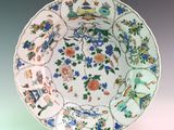 a plate with a bird and flowers design on it