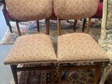four upholstered chairs in a room with a rug and a rug on the floor