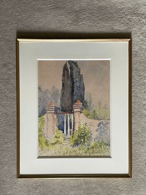 framed watercolor painting of a stone wall with a building in the background