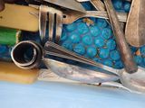 a blue container filled with silverware and spoons
