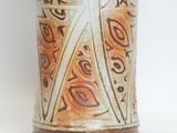 a brown and white vase sitting on a white surface
