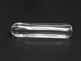 a clear glass pill sitting on top of a black table