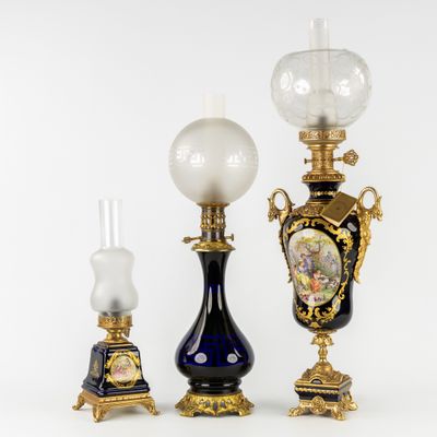 three different types of vases and a lamp on a white surface