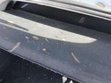 an open trunk of a car with a surfboard in it