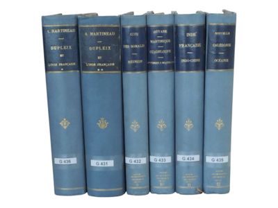 six blue books are lined up in a row on a white surface
