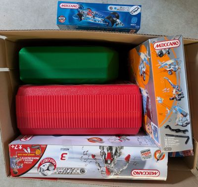 three boxes of toys in a cardboard box on the floor