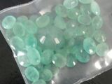 a bag of green stones sitting on a table