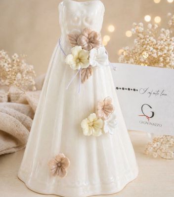 a small figurine of a dress with flowers on it