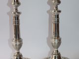 pair of silver candlesticks on a white background