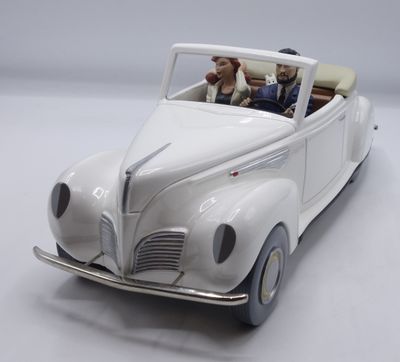 a white toy car with a man and a dog in it