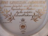 a plate with a gold and white design on it