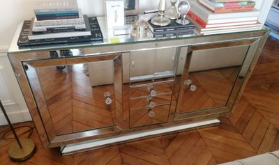 a glass table with books and a lamp on it