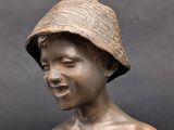 a bronze statue of a woman with a hat on her head