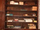 a wooden cabinet with a lot of books on top of it
