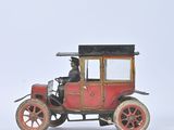 a small toy car that is sitting on a white surface