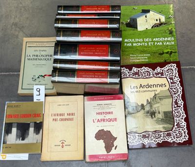 several books are sitting on the ground next to each other