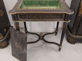 a small table with a green glass on top of it