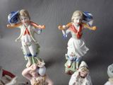 many figurines of children playing baseball on a table