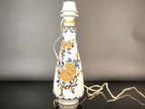 a white vase with a blue and yellow design on it