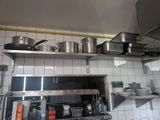 pots and pans on the shelves in the kitchen