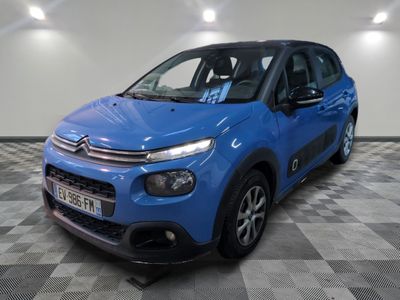 a blue citrole is parked in a room with a checkered floor