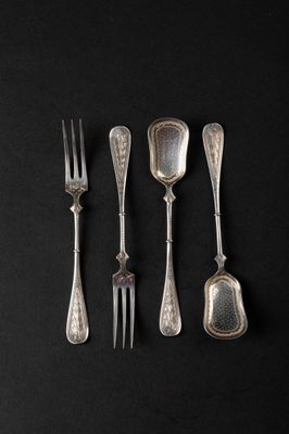 four forks and spoons on a black surface with a black background