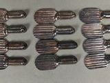 six pieces of metal are arranged in a row on a table