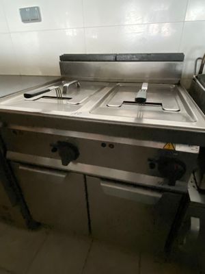 a picture of a commercial kitchen with two sinks and a stove