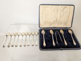 several silver spoons and spoon spoons in a case on a table