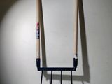 two baseball bats sitting on a stand in front of a white board