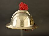 a silver helmet with a red pom pom on it