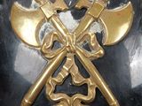 a helmet with two crossed axes on it and two crossed axes on the front