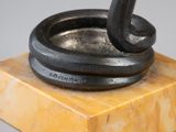 an image of a sculpture of a black cat on a marble base