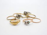 five different types of rings on a white surface