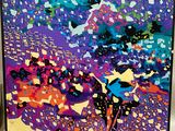 painting of a colorful abstract painting on a white wall with a black frame
