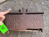 a hand holding a piece of metal that has a green tag on it