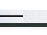 une console Xbox One blanche posée sur une table blanche