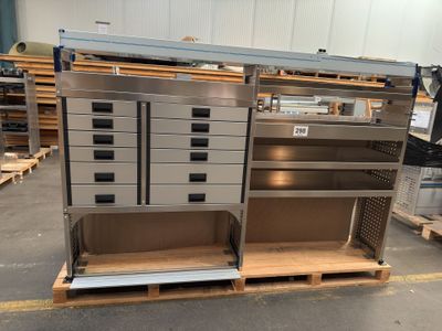 a metal cabinet with drawers and shelves in a warehouse