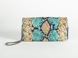 a snake skin clutch bag with chain strap and chain closure