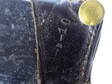 a close up of an old book with a button on it