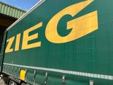 un semi-remorque vert avec un logo Zieg jaune sur le côté