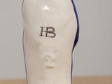 a small ceramic figurine of a hand with the letter b on it