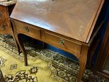 a wooden desk with a mirror on top of it